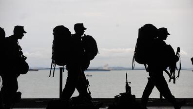 Image of three soldiers marching