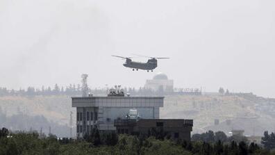 A U.S. Chinook helicopter flies near the U.S. Embassy in Kabul, Afghanistan, Sunday, Aug. 15, 2021.