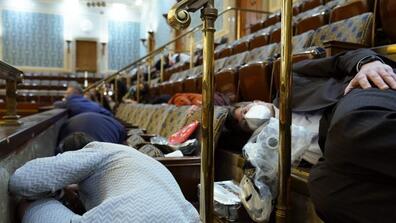 People shelter in the House gallery.