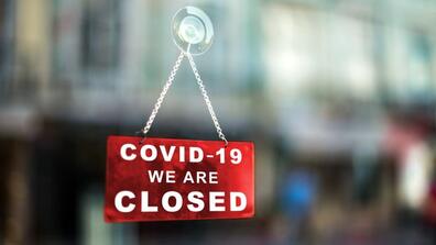a sign on a door that reads covid-19, we are closed