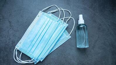 face masks and a bottle of hand sanitizer