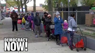 People waiting as a long line with their shopping trolleys