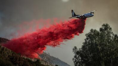 A plane dropped fire retardant ahead of the Kincade fire in the Geysers, Calif.