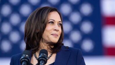 Image of Kamala Harris with an American flag on the background