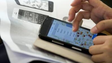 A journalist tries out a real-time air quality app on her smartphone in Beijing, China, June 9, 2014