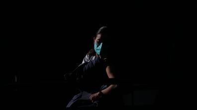 A doctor receives the vaccine against COVID-19